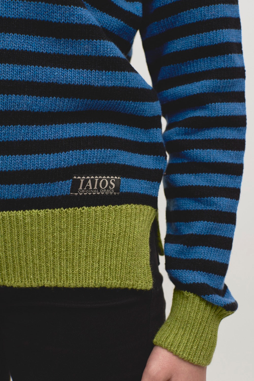 Detalle del tejido del jersey Truth de rayas negras y azules con canales pistacho, elaborado con hilo reciclado en pequeños talleres de Catalunya, moda sostenible y duradera.