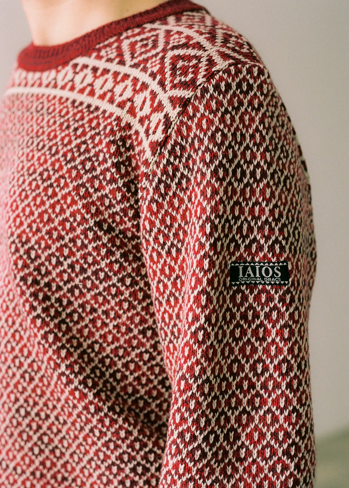 Jersey de hombre IAIOS rojo y blanco con motivos navideños, detalle del tejido, moda sostenible elaborada con hilo reciclado en talleres de Catalunya (España).
