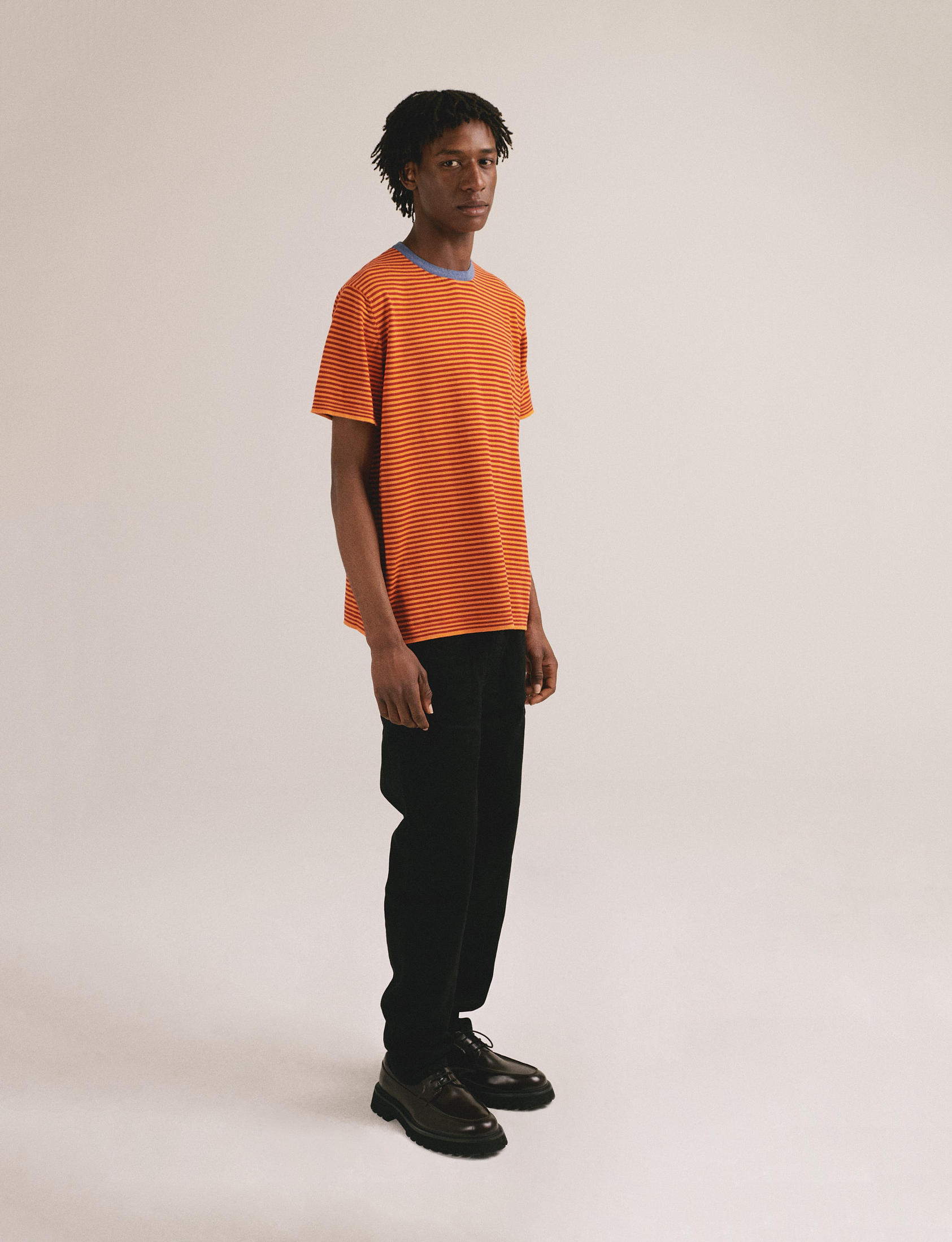 Camiseta de punto de rayas con tonos naranja y cuello azul. Algodón orgánico y fabricación local.