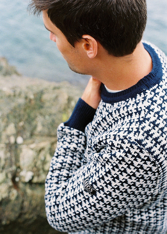 View of the sweater in side detail. In the photo you can see the texture and pattern of the design.