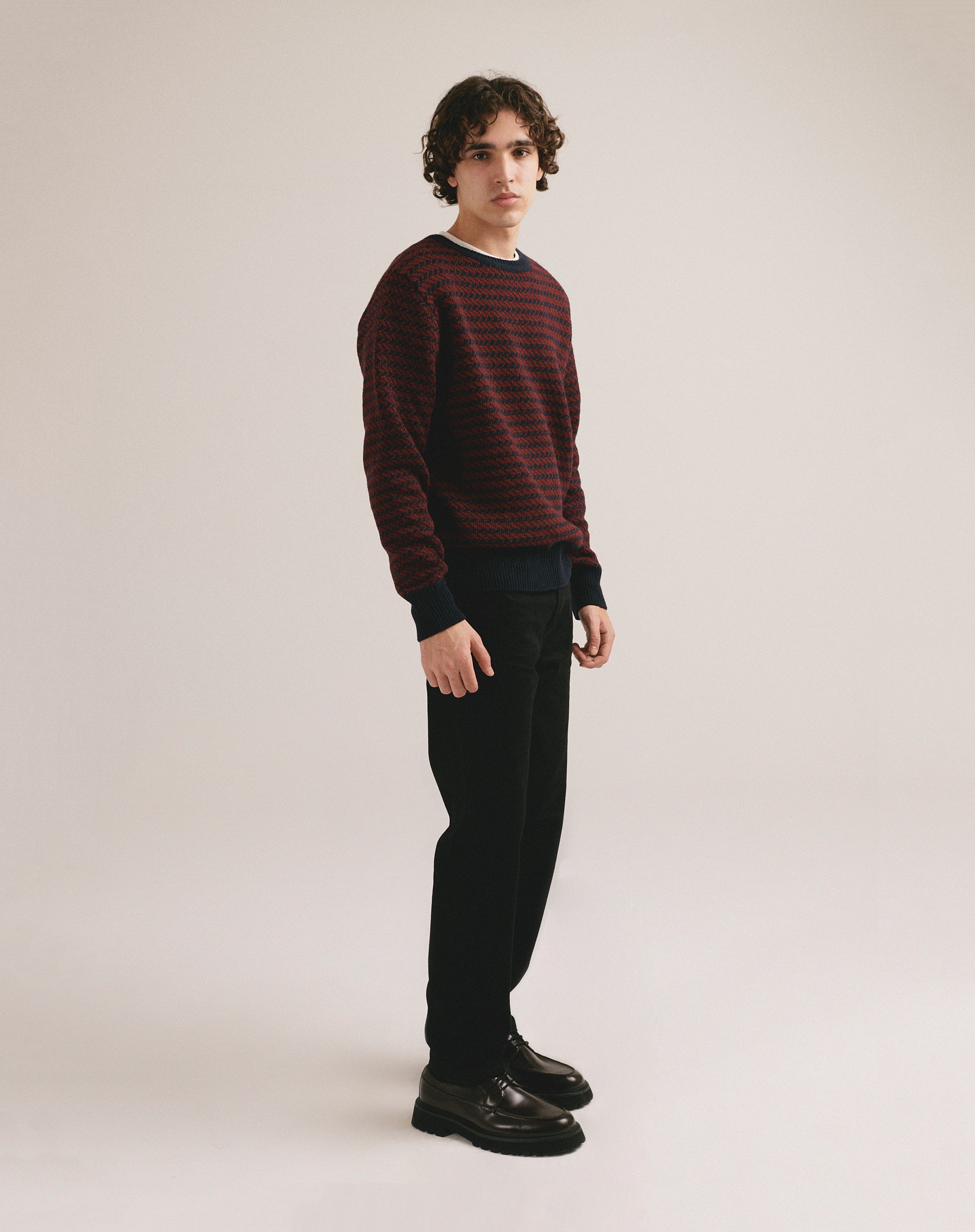 Hombre con jersey de punto rojo y negro con diseño texturizado