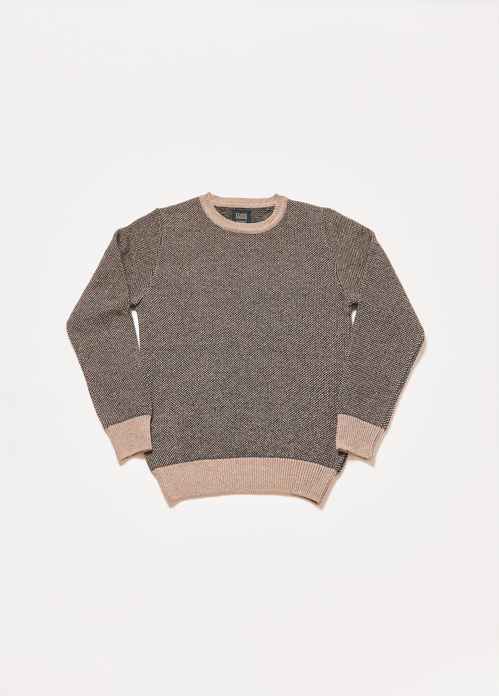 Jersey unisex IAIOS negro y beige en punto grano de arroz, moda sostenible, fotografía en plano (flat lay), hecho en Catalunya (España) con hilo reciclado.