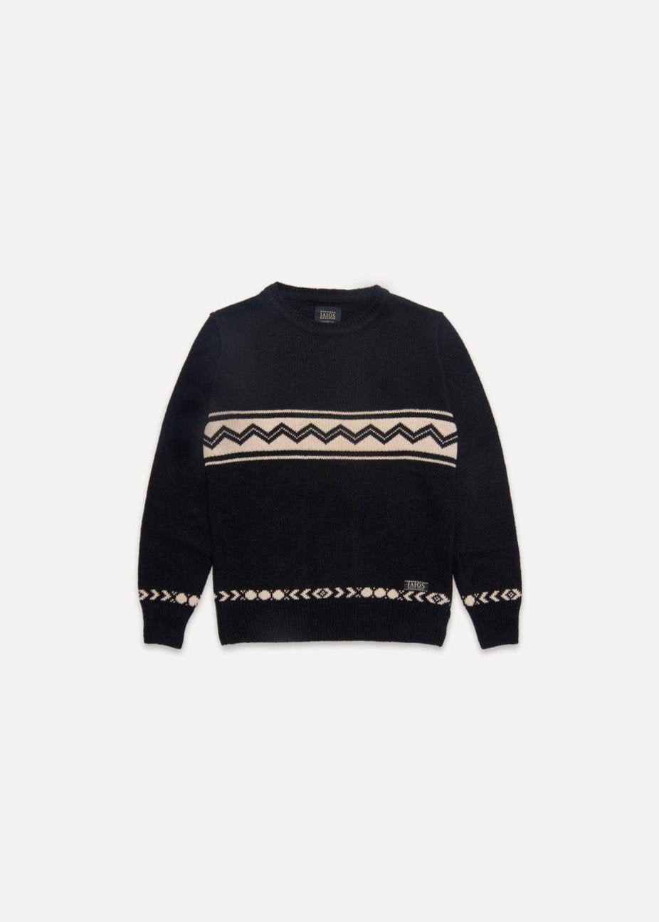 Jersey IAIOS de mujer en negro con motivos en crema, moda sostenible, fotografía en plano (flat lay), hecho en Catalunya (España) con hilo reciclado.