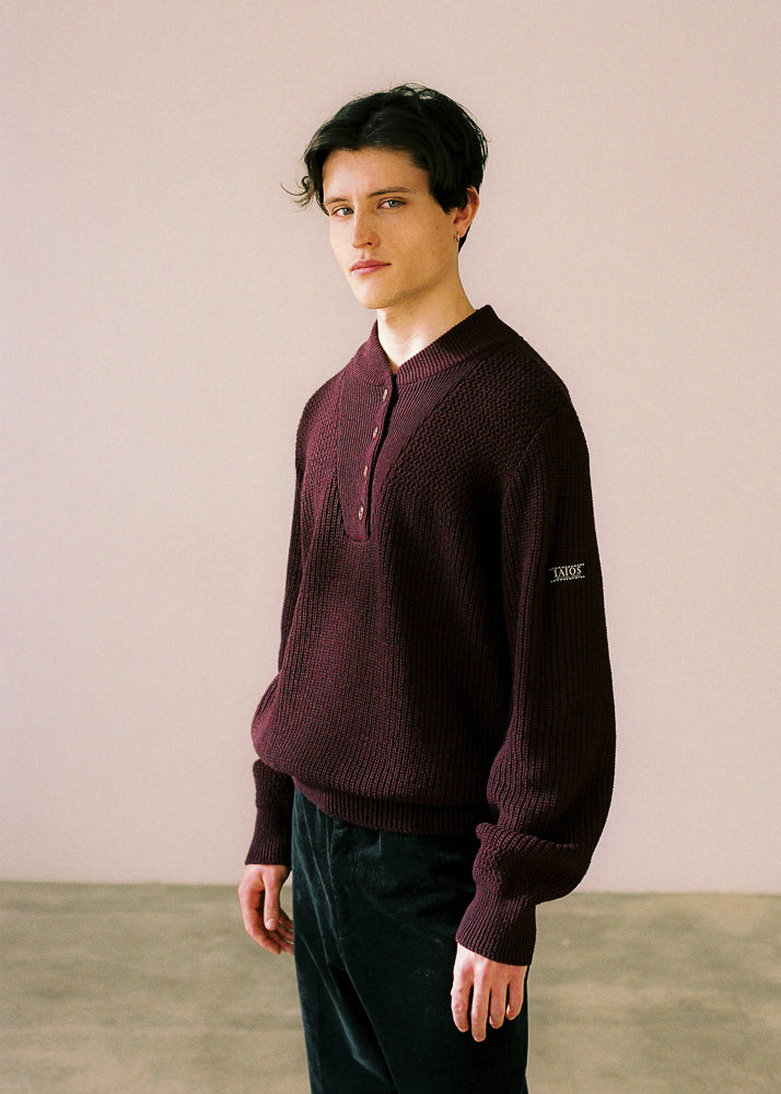 El modelo lleva el jersey IAIOS oversize unisex color granate con botones, moda sostenible elaborada en pequeños talleres de Catalunya (España) con hilo reciclado.
