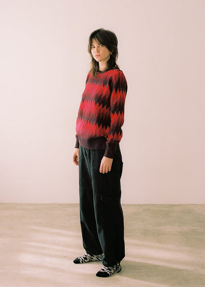 Full body photograph, sweater combined with black pants.
