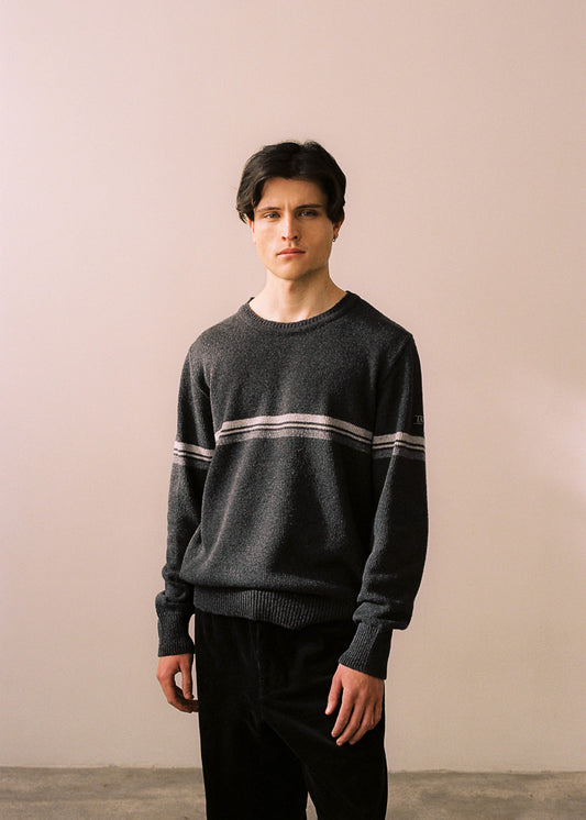 Half body shot of the model with the sweater on combined with black pants.