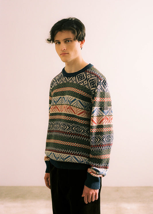 Photograph of the model wearing the sweater in side view.