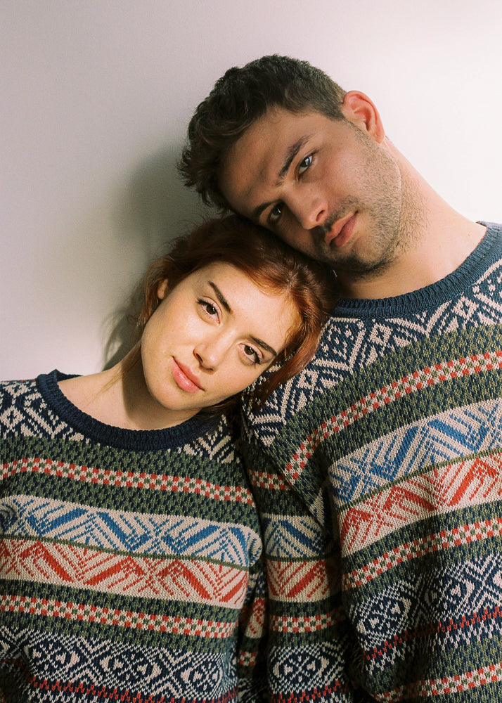 photograph of two models, boy and girl, wearing the same model of sweater.