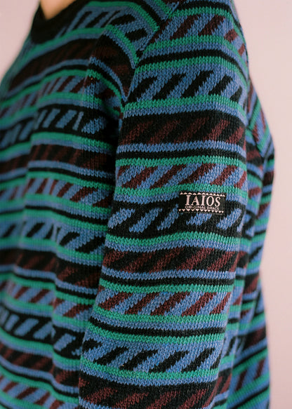 Fotografia de detall de l' etiqueta amb el logo de IAIOS a la part externa de la màniga. 