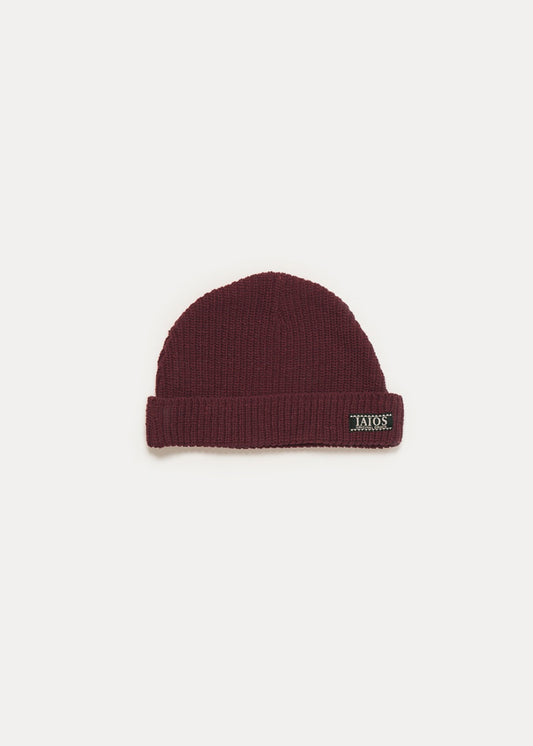 Wine colored beanie for winter. It is a basic and plain hat.