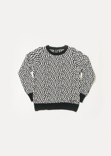 Women's or unisex sweater in black and white. It is a jacquard that imitates zebra-like spots.