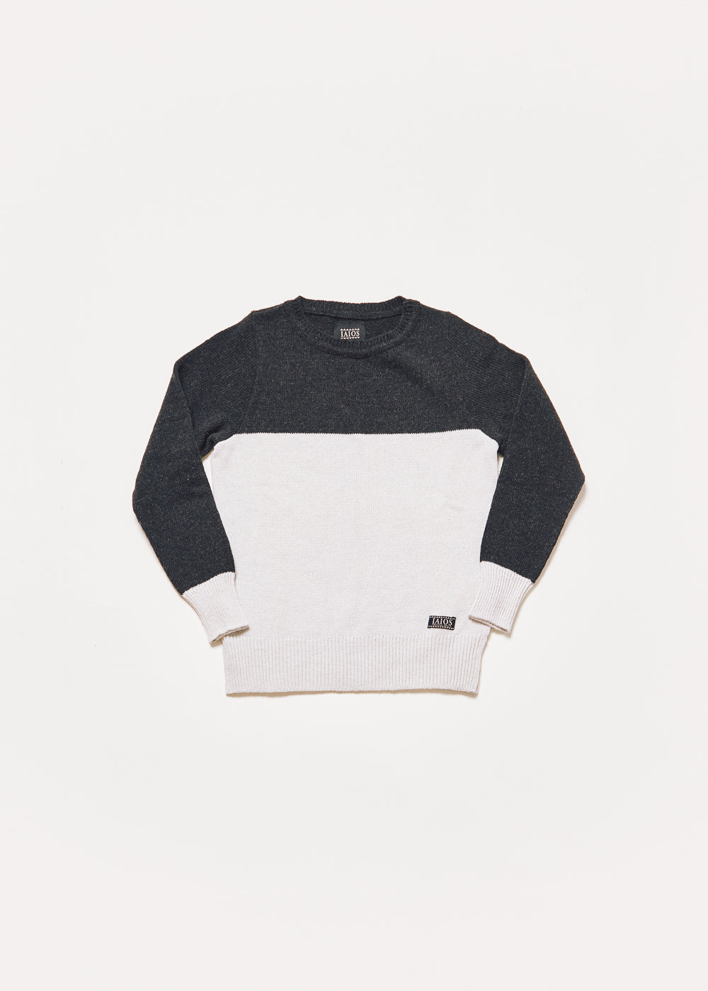 Women's or unisex knitted sweater in which the upper half is black and the lower half is white. 